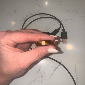 Oura Ring in Gold with Black Charging Cable